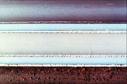 Figure 33-1. Inside surfaces of 3/4 in. steel heat exchanger tubes. Top: typical steel surface, unexposed, prior to use. Middle: surface exposed to cooling water following pretreatment. Bottom: surface exposed to treated cooling water with no pretreatment.