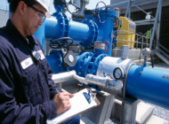 man inspecting mechanism